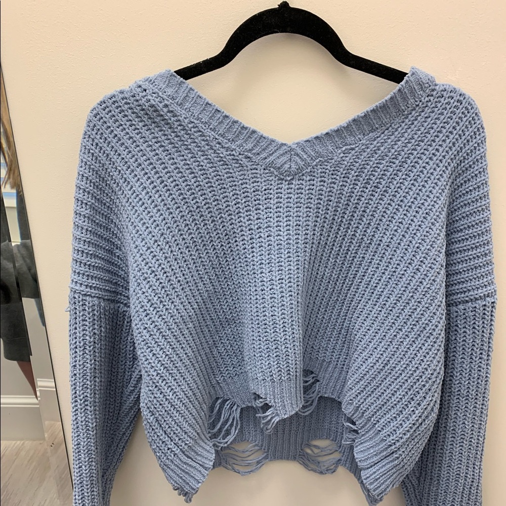 blue crossed sweater
